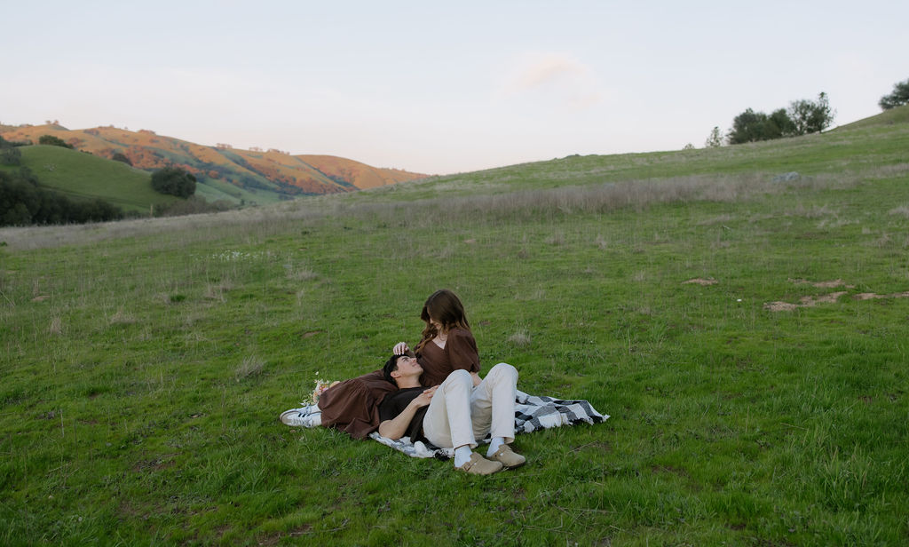 A woman playing with her fiances hair during engagement photos