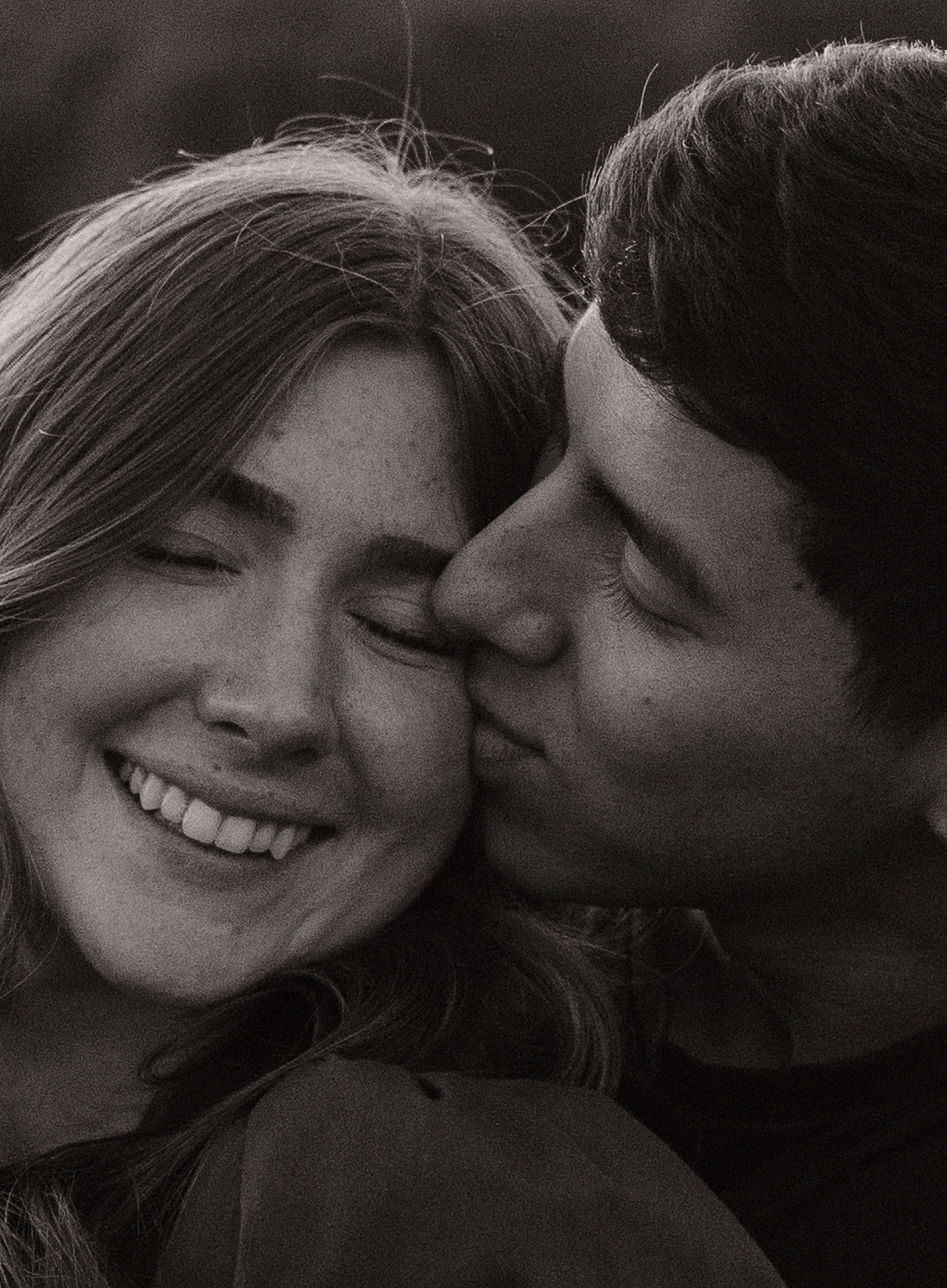 A black and white photo of a couple during their engagement photos