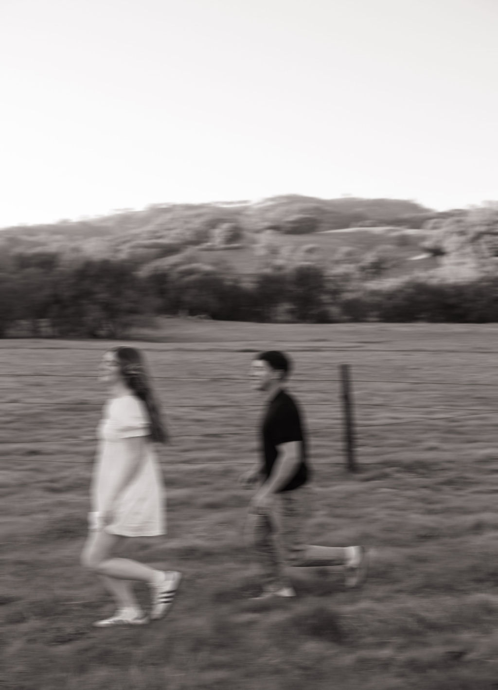 A couple running in a blurry engagement photo idea