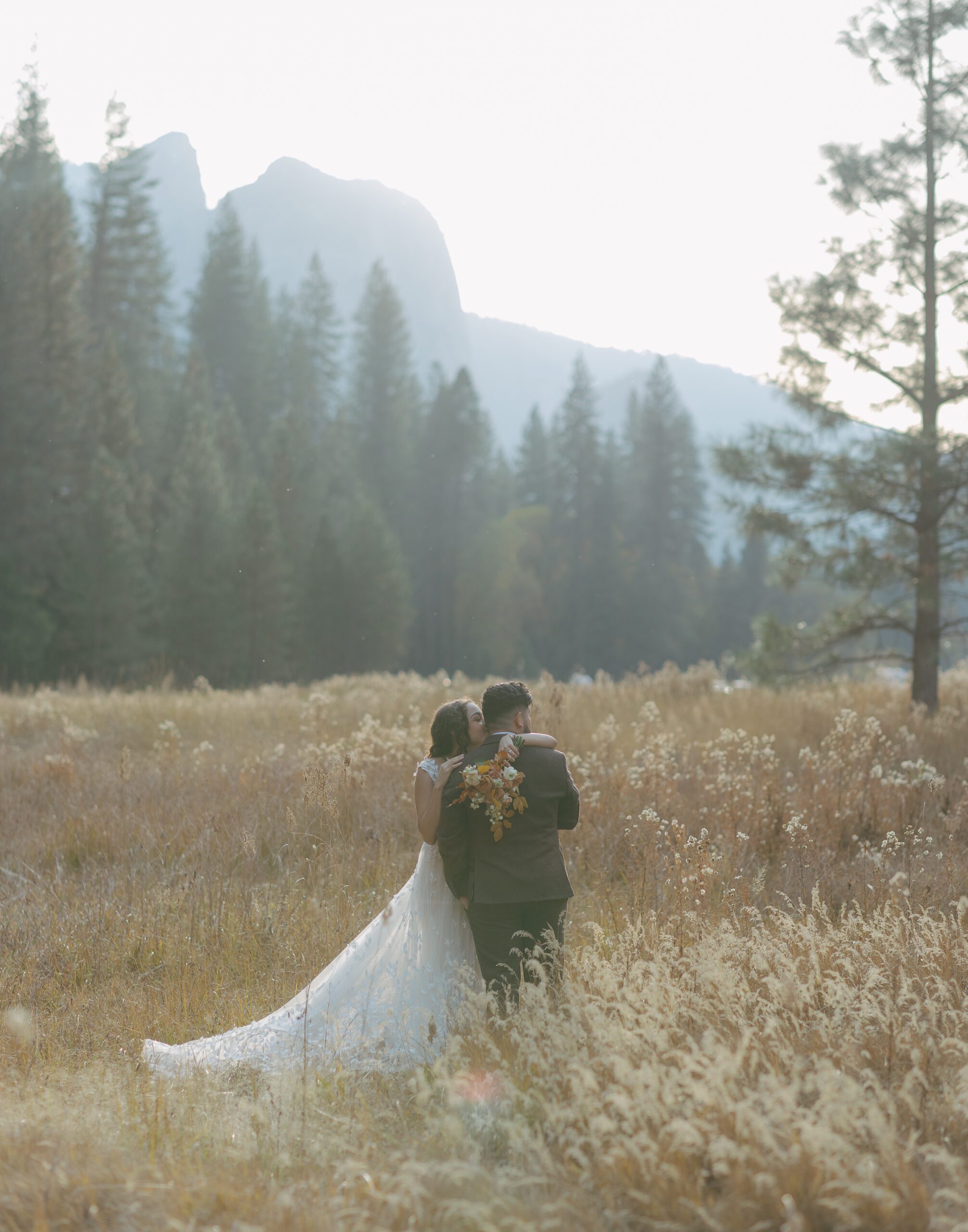 A bride and groom posing for wedding photos in Yosemite National Park