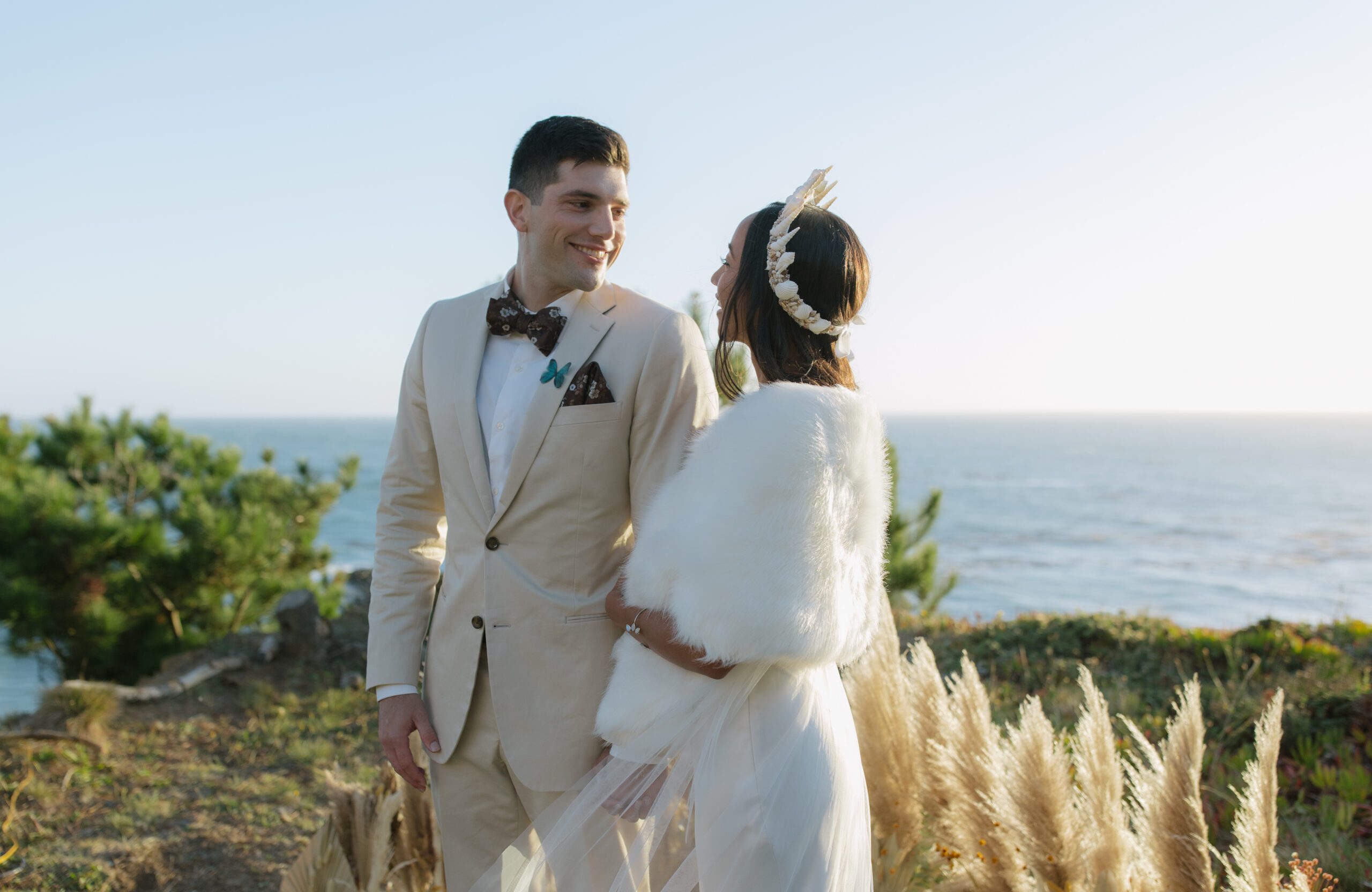 A bride and groom posing for wedding photos on the coast of Northern California 