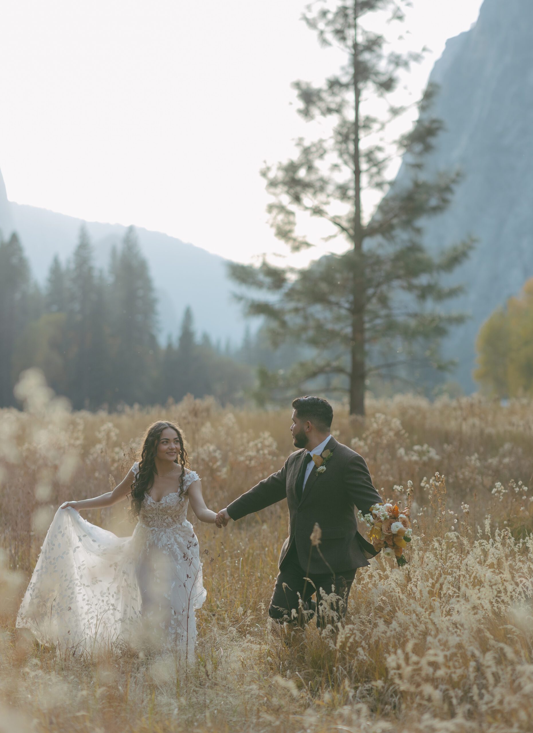 A bride and groom posing for wedding photos in Yosemite National Park