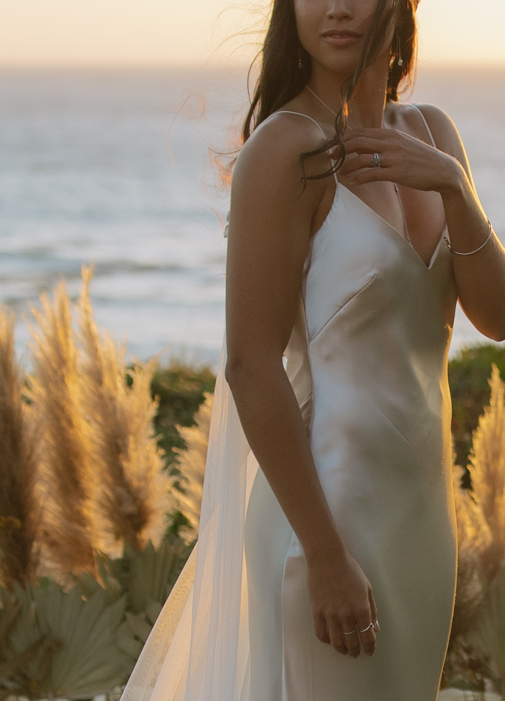 A bride taking sunset wedding photos in Northern California wedding location Bodega Bay