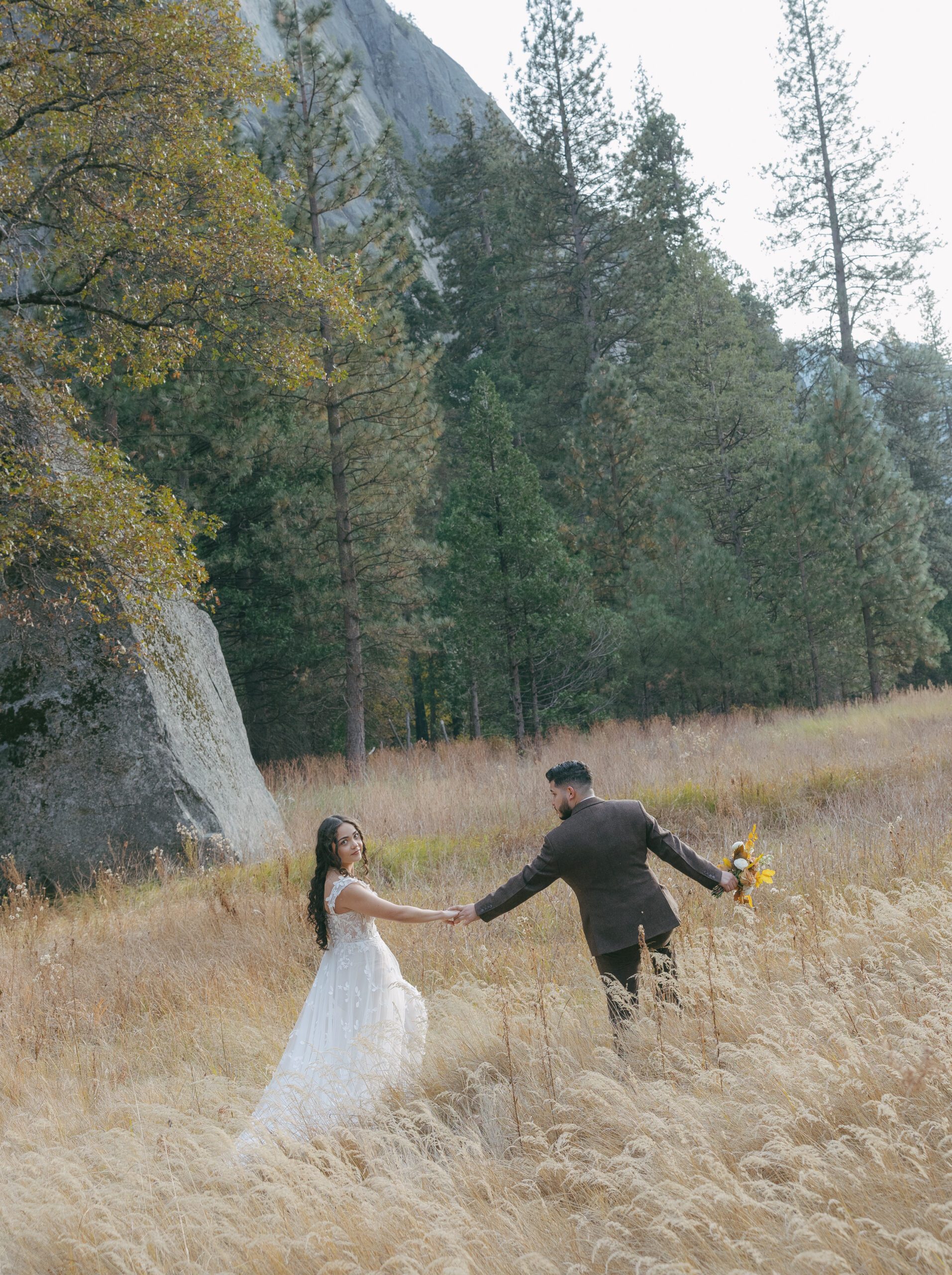 A bride and groom posing for wedding photos in Yosemite National Park