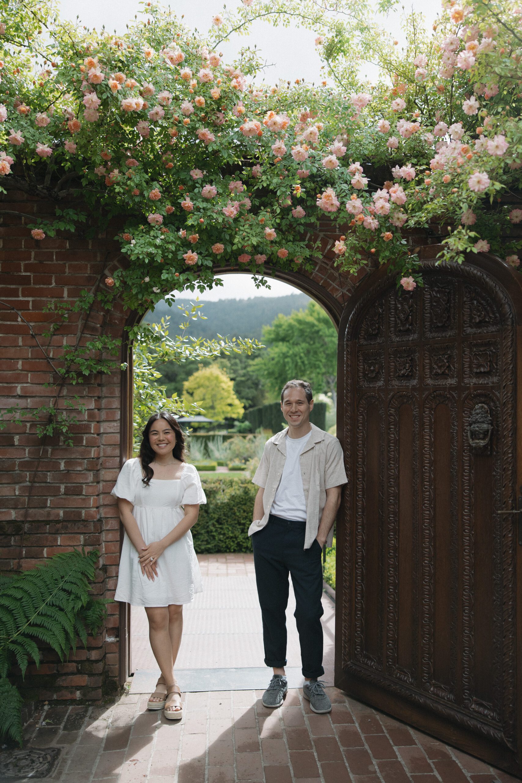 A couple posing for photos at NorCal wedding venue Filoli