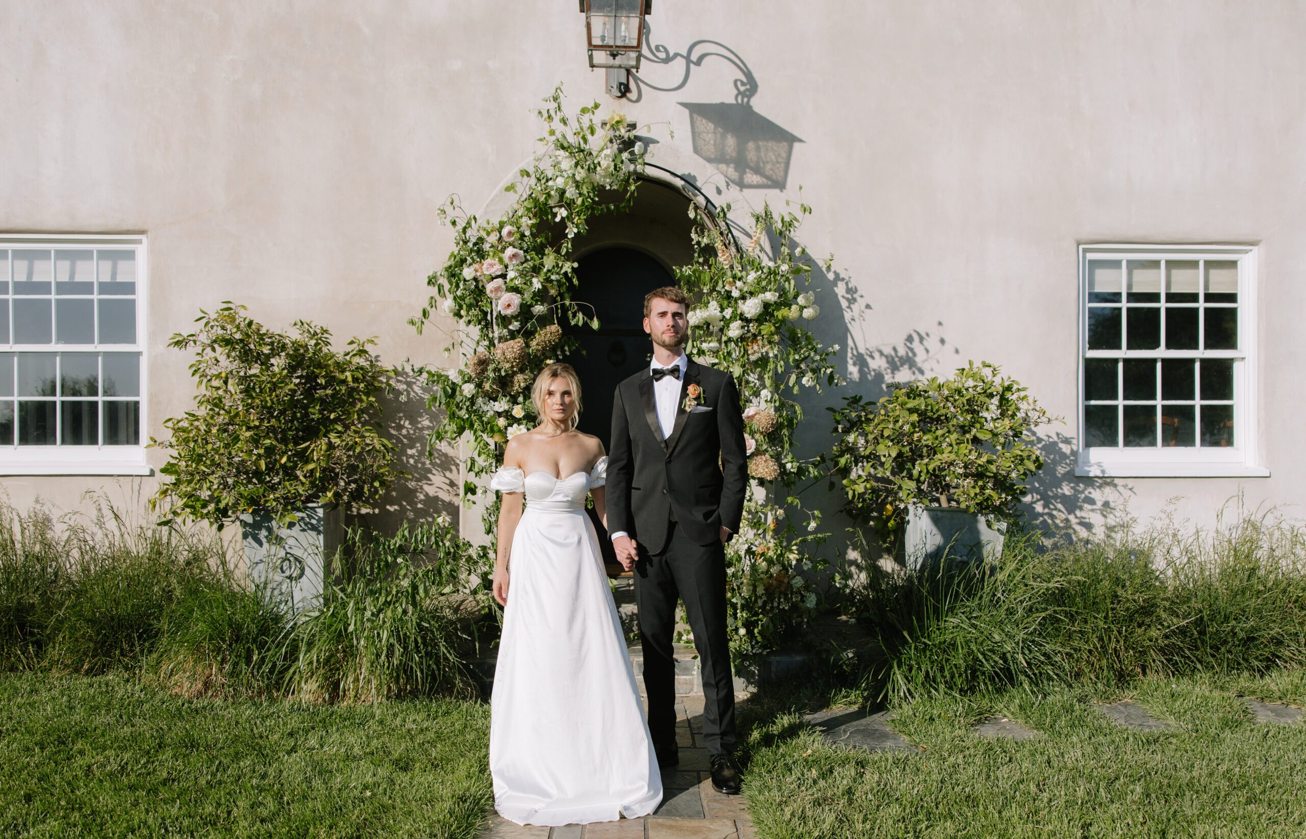 A bride and groom posing in front of their NorCal wedding venue, Cavaignac