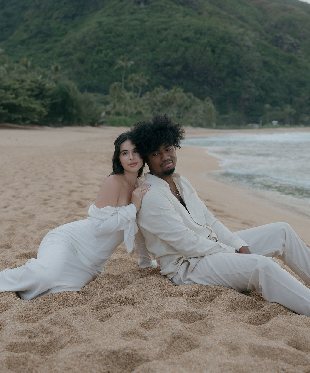 A couple sitting on the beach after their Kauai elopement