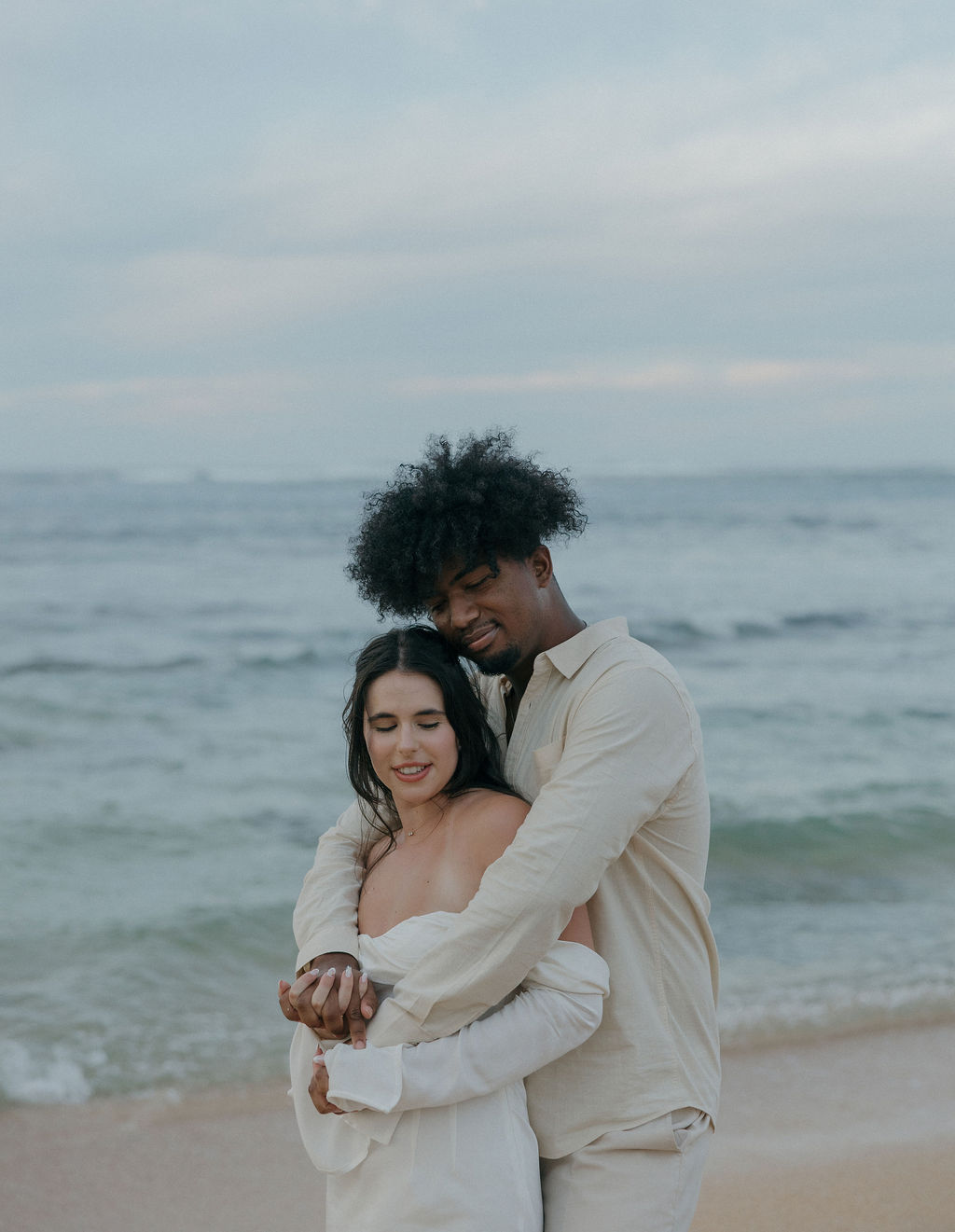 A bride and groom taking beach elopement photos in Kauai