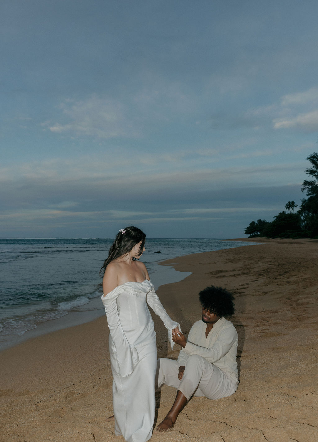 An elopement couple on Kauai Tunnels Beach at sunset