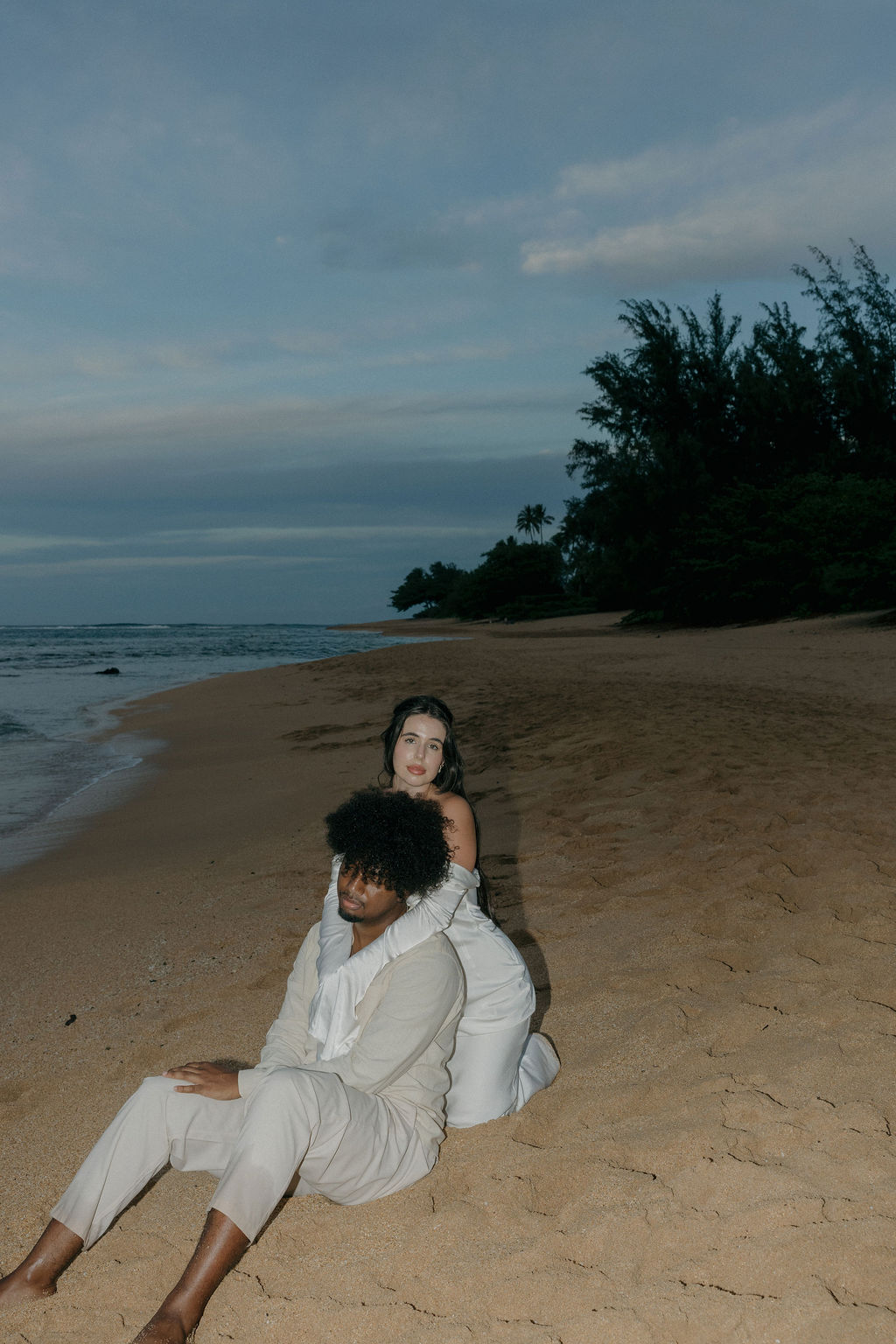 An elopement couple on Kauai Tunnels Beach at sunset