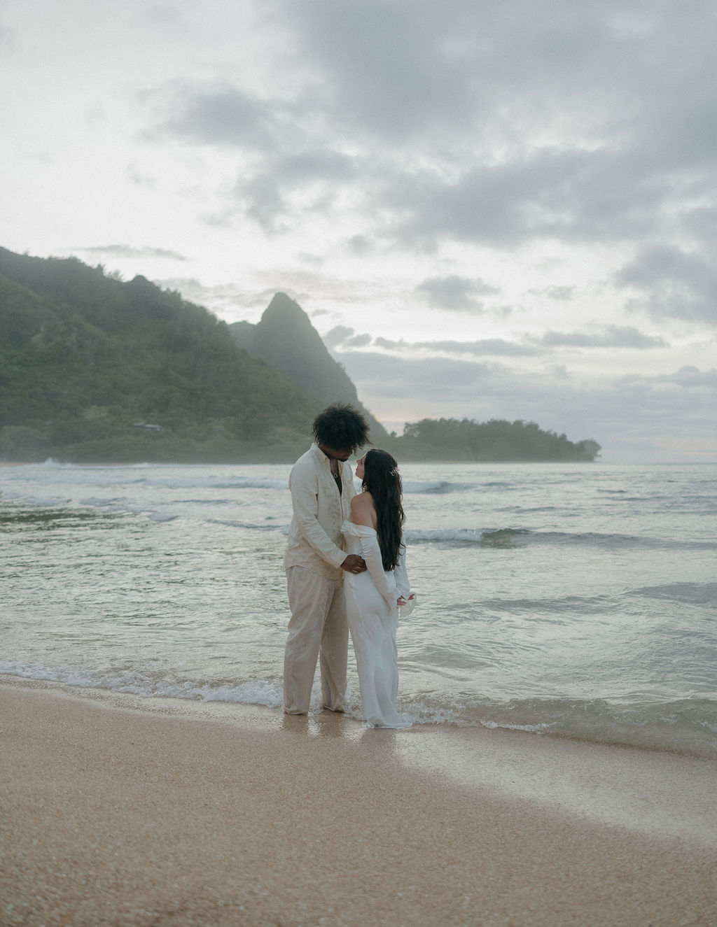 A bride and groom posing for Hawaii elopement photos in Kauai