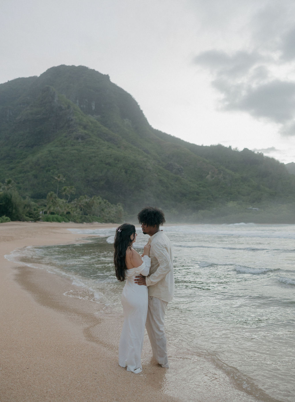A bride and groom posing for Hawaii elopement photos in Kauai