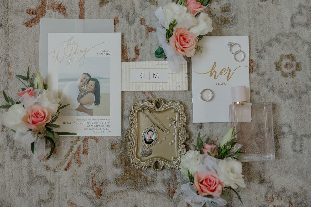 A wedding flat lay with wedding invitations and wedding jewelry