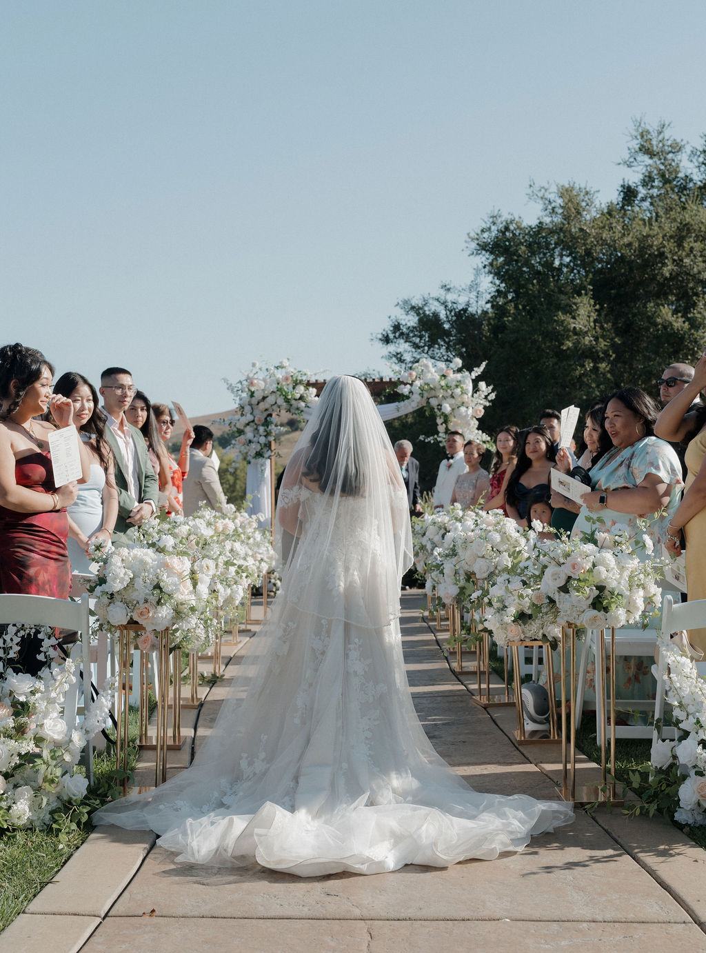 A bride walking down the aisle In a wedding photo captured by a Sacramento wedding photographer from her wedding vendor checklist