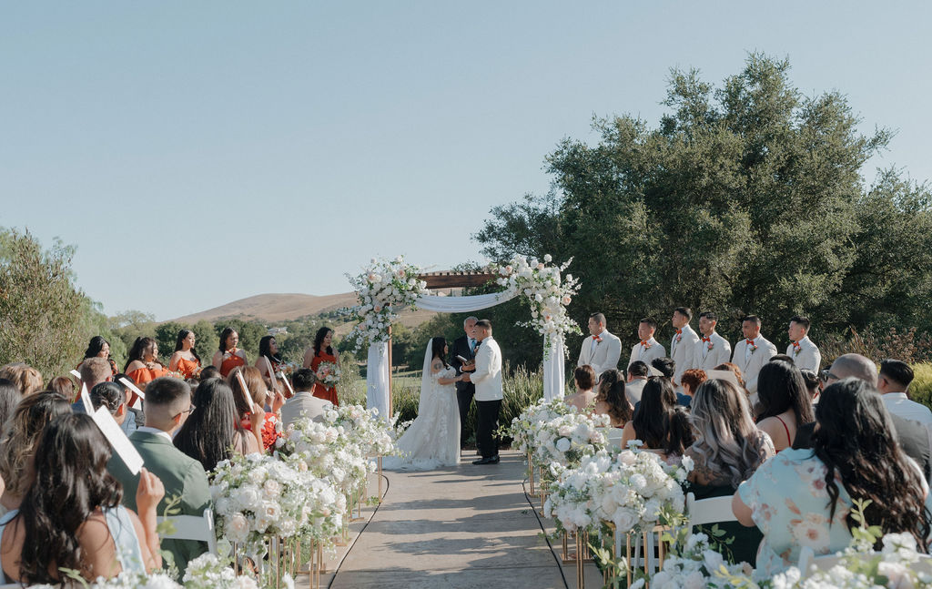 A bride and groom at their outdoor wedding ceremony