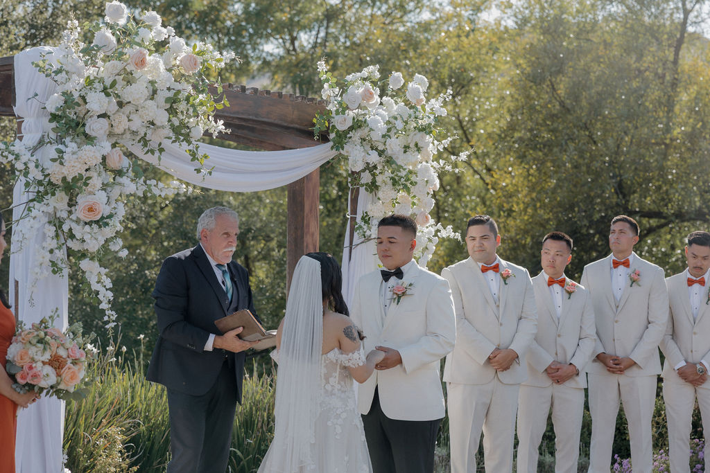 A wedding ceremony being performed by a wedding officiant from a wedding vendor checklist