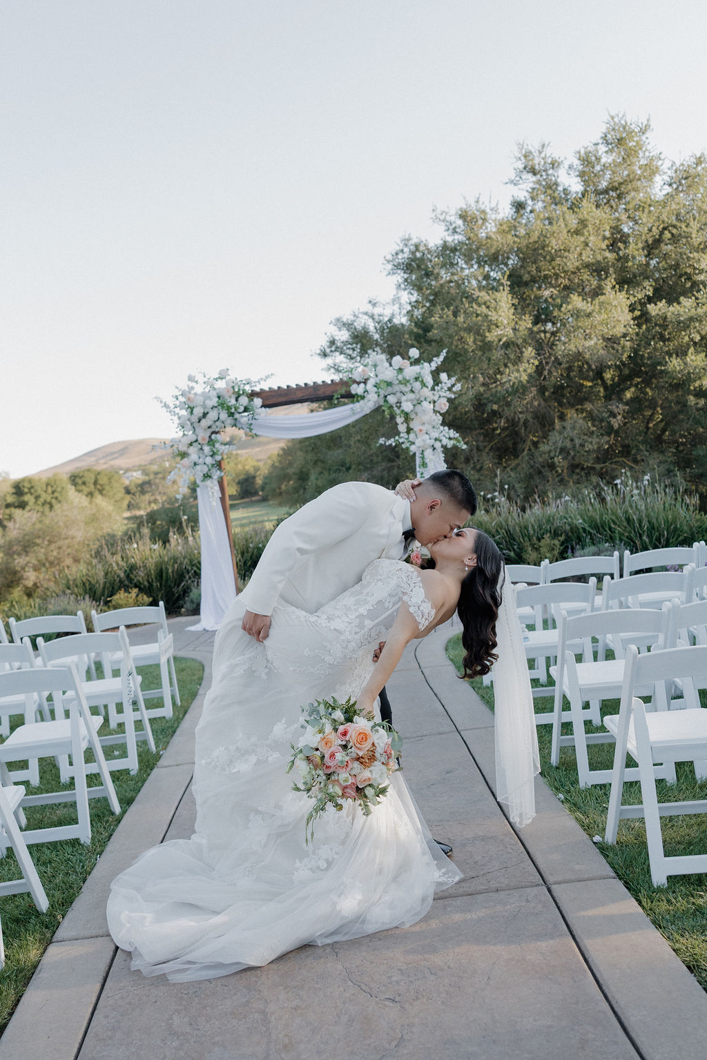 A groom dipping a bride for a kiss