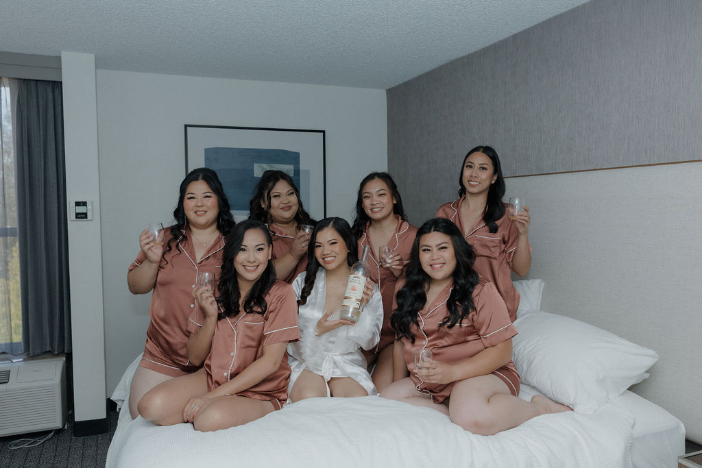 A bride and bridesmaids posing in their wedding hotel block