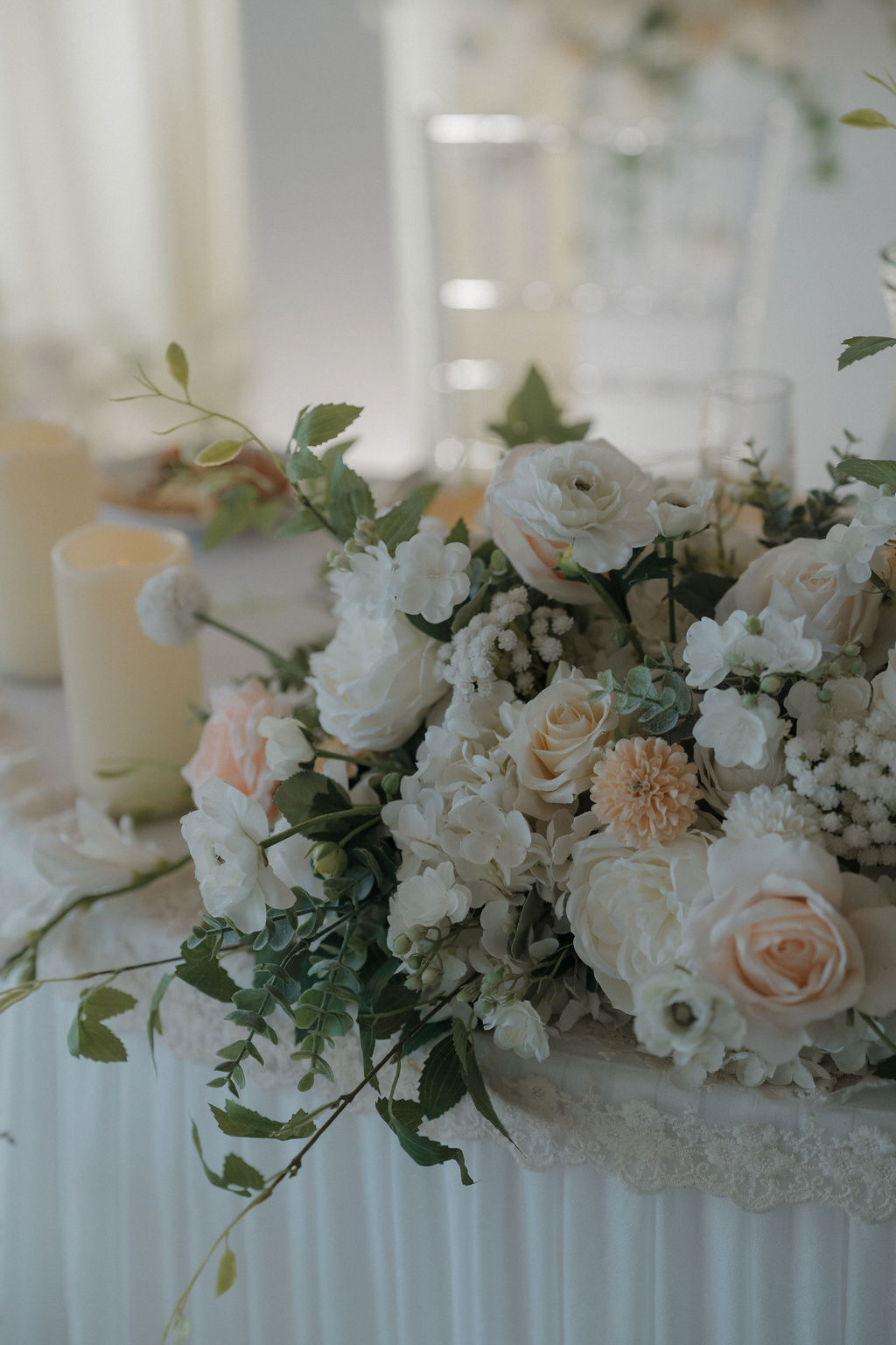 A sweetheart table decorated with wedding flowers by a florist from a wedding vendor checklist