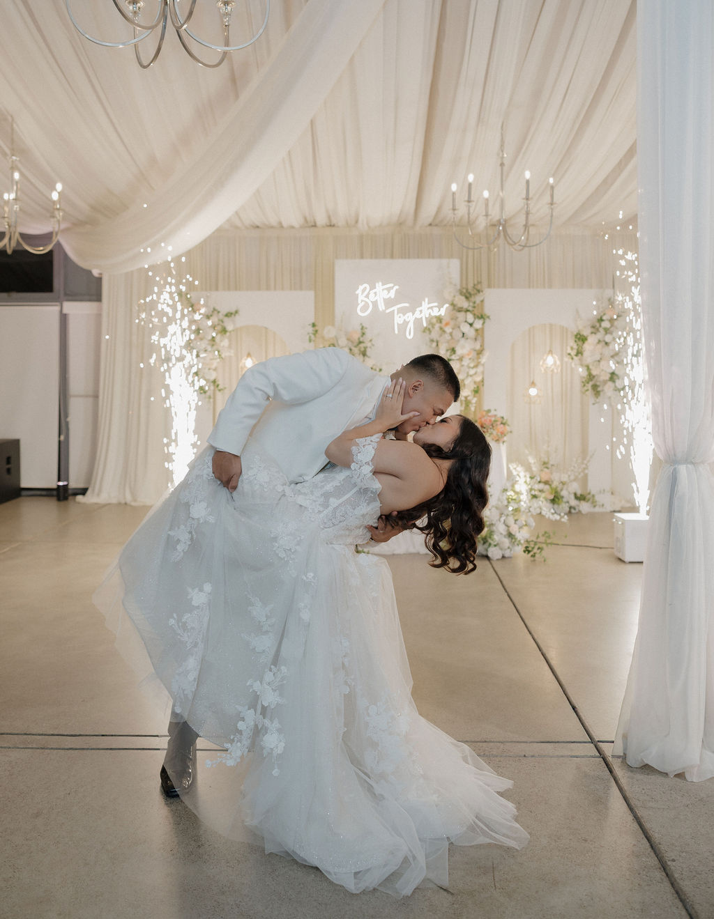 A bride and groom kissing at their wedding reception