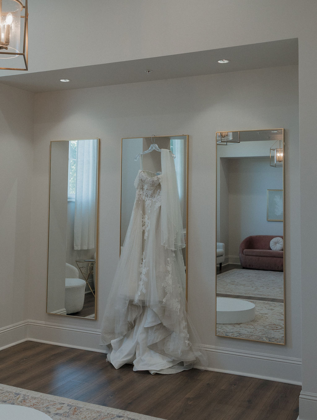 A wedding dress hanging in a bridal suite