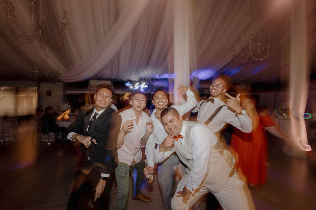 Candid wedding photos of guests dancing to a DJ selected off of a wedding vendor checklist