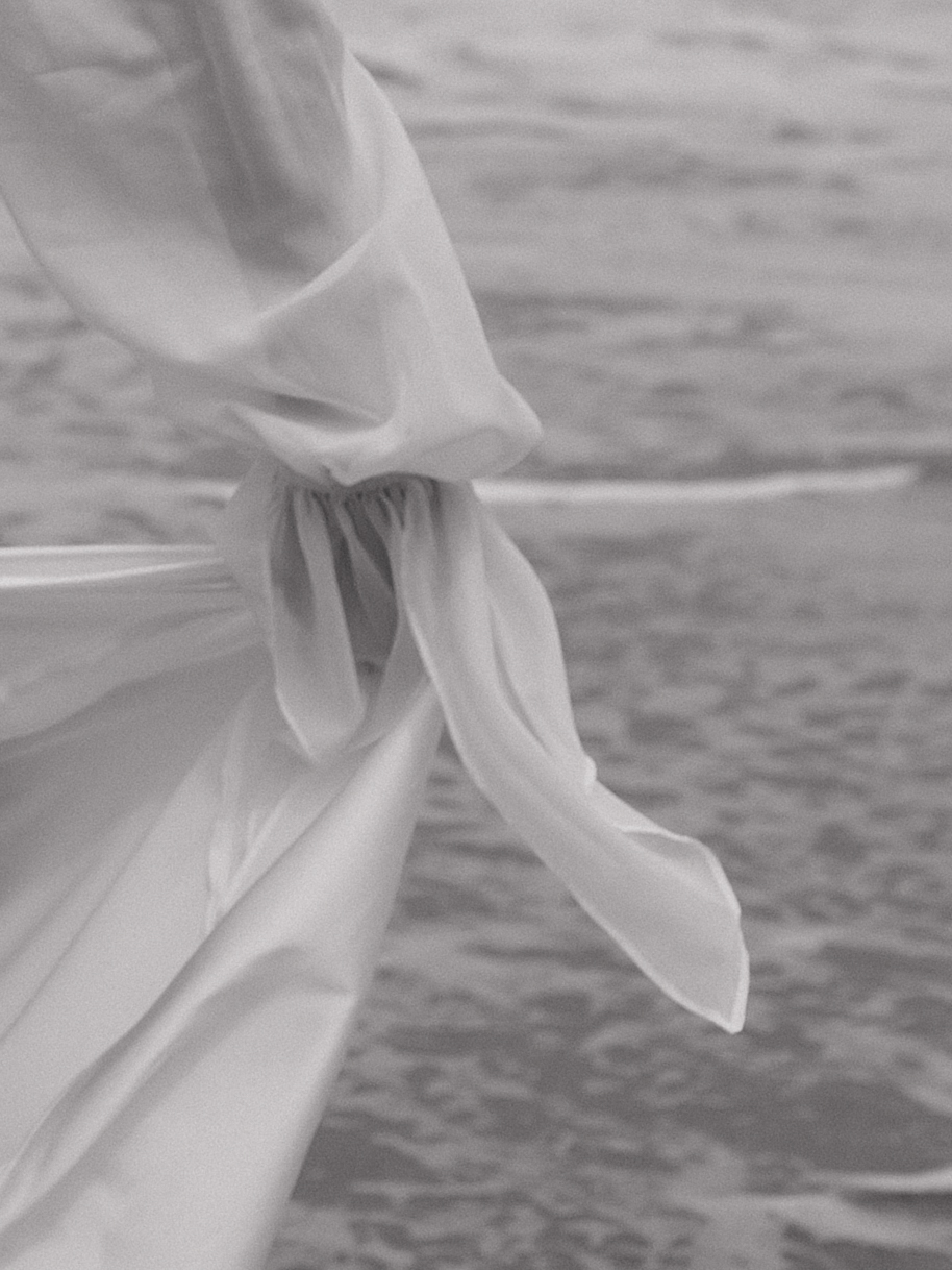 A black and white photo of a beach engagement photo shoot dress