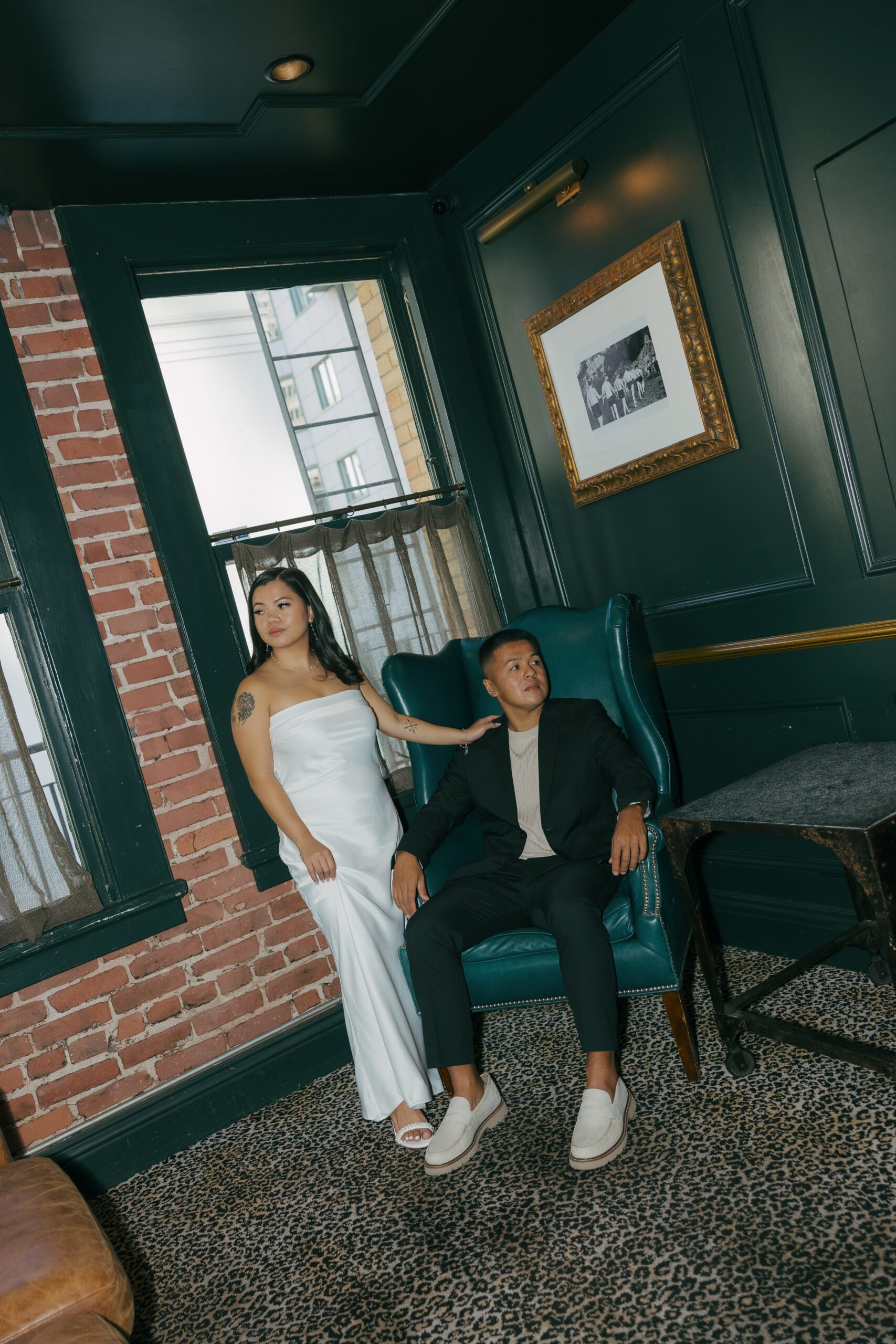 A couple posing for photos in classy engagement photo outfits