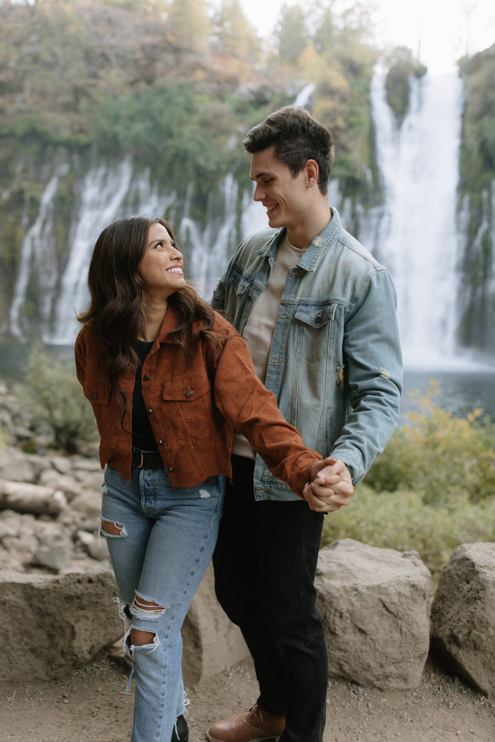 A couple wearing denim outfits for mountain engagement photos