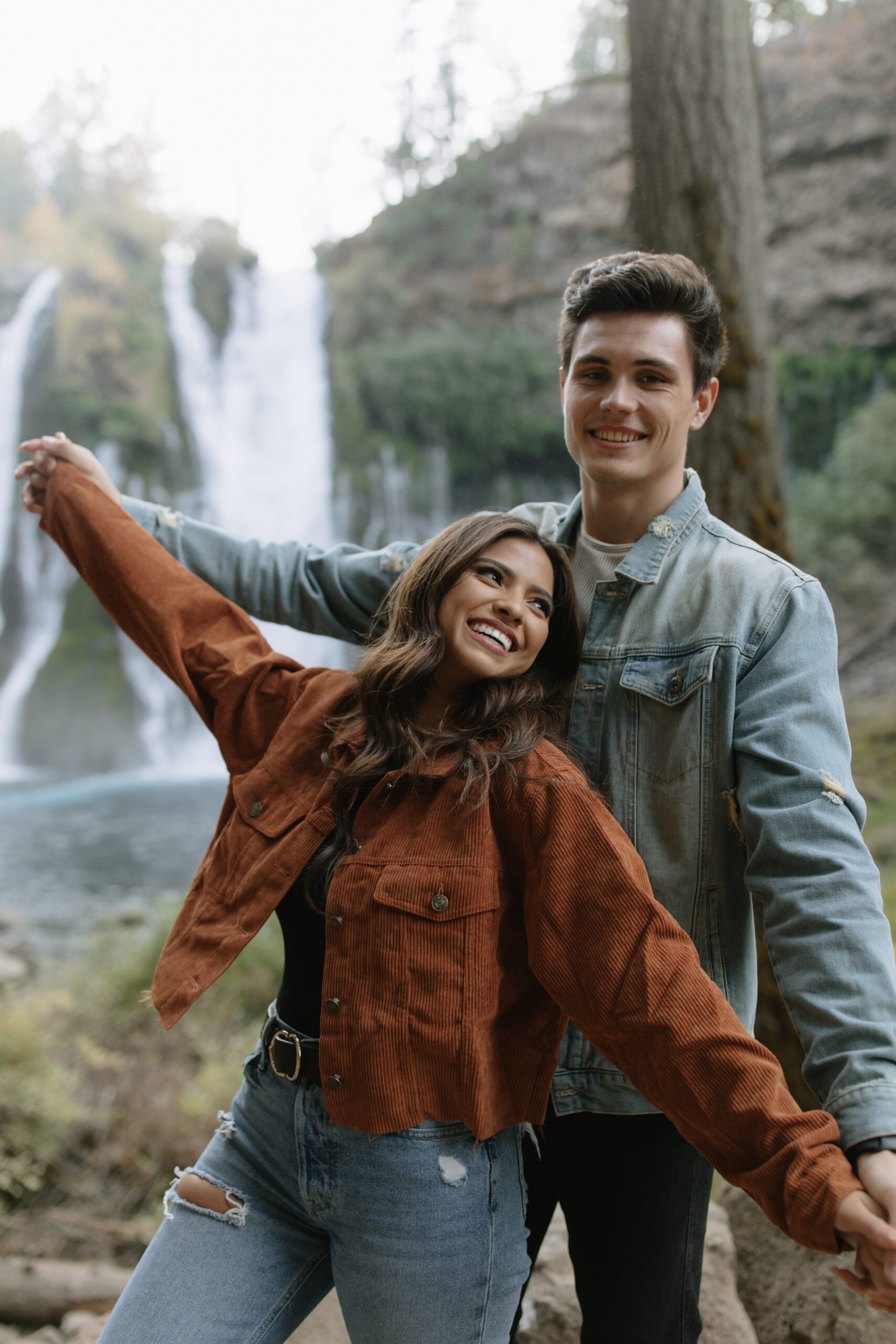 A couple wearing denim outfits for mountain engagement photos