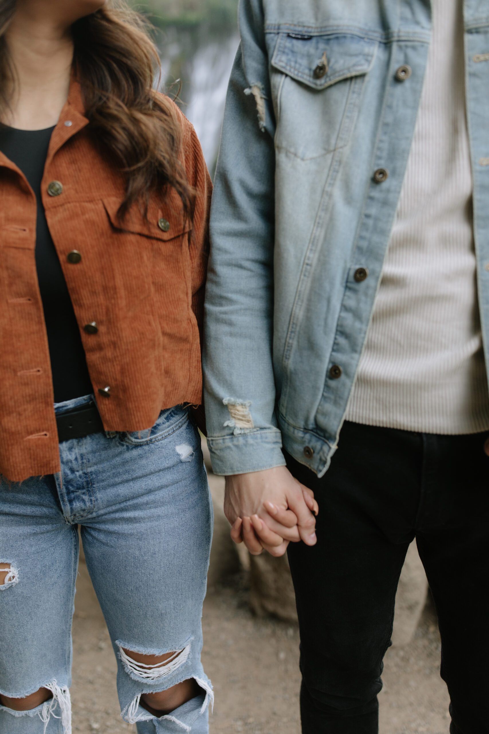 A couple wearing denim outfits for mountain engagement photos