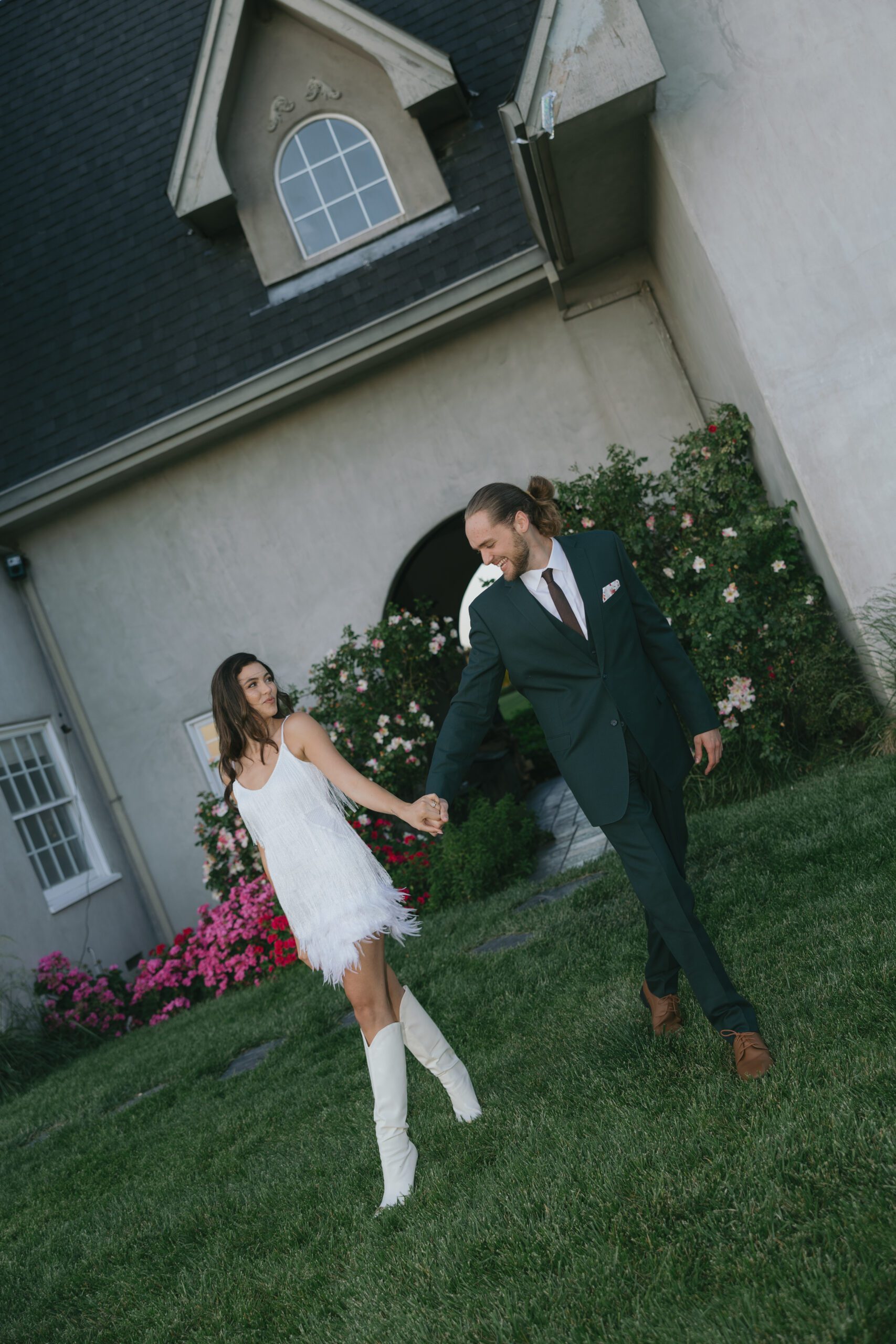 A couple wearing funky engagement photo shoot outfits for a western themed engagement photo shoot