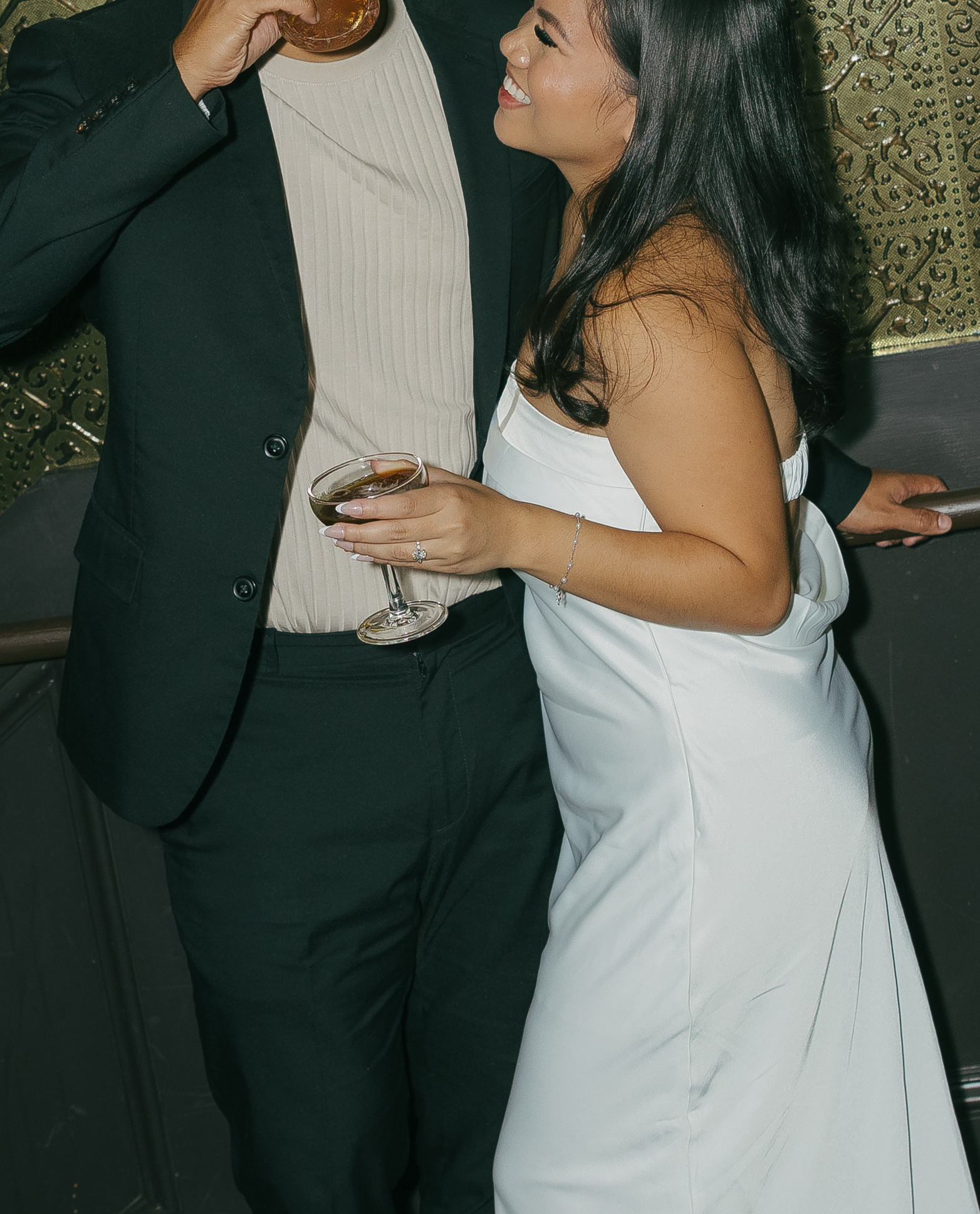 A couple posing for photos in classy engagement photo outfits