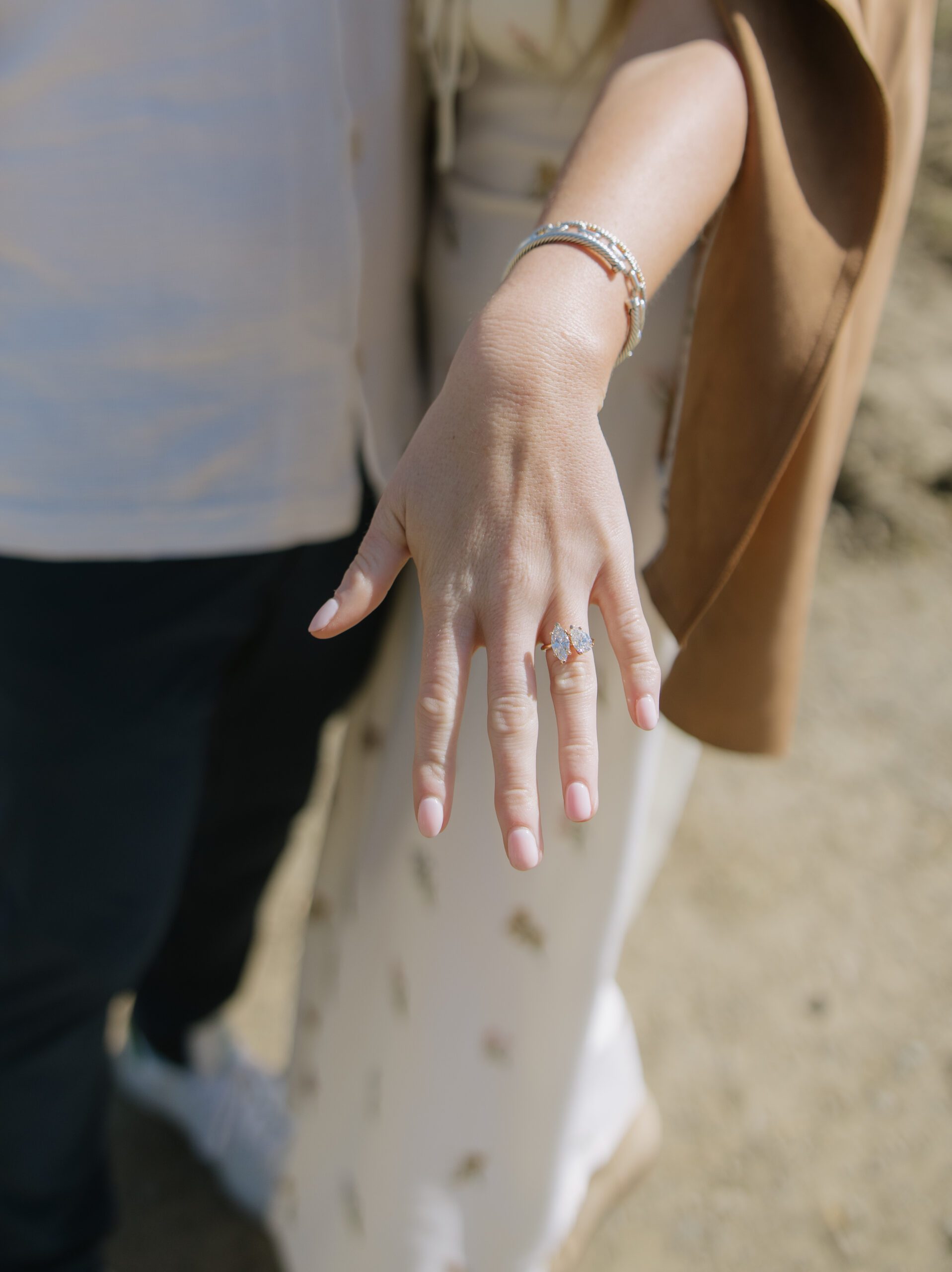 A woman showing off her engagement ring after a proposal