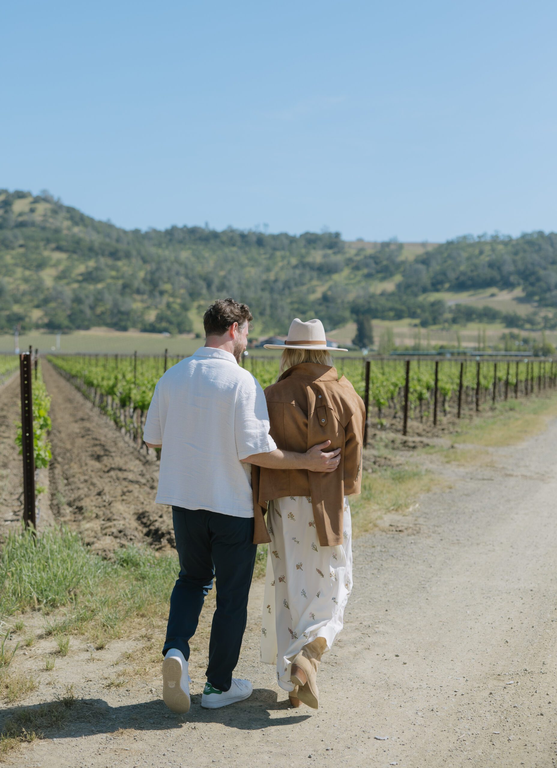 A romantic proposal idea of taking engagement pictures in a vineyard after getting engaged
