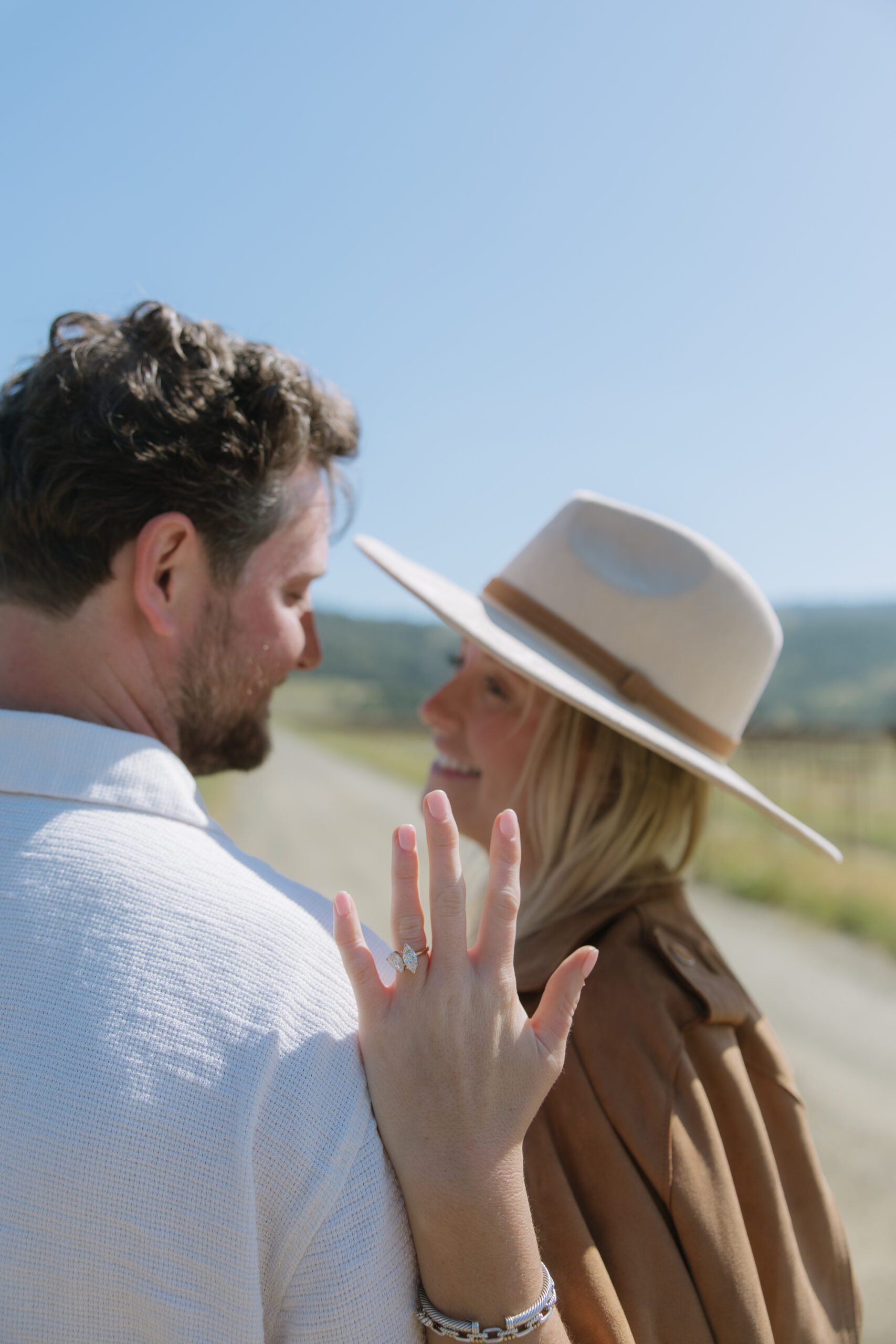 A woman showing off her engagement ring after a romantic proposal