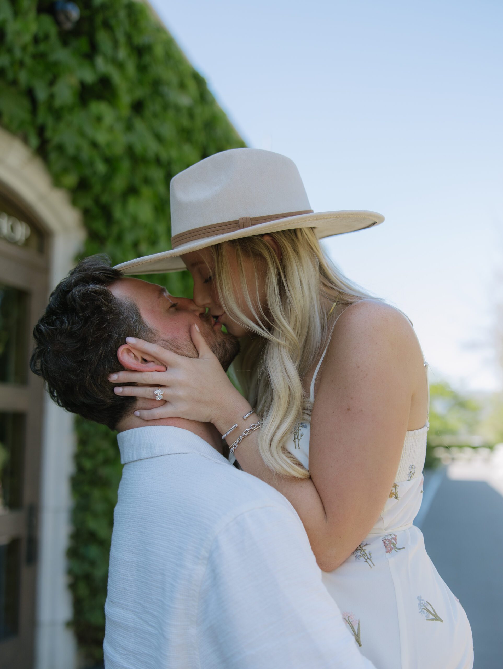 A couple kissing during engagement photos after getting engaged