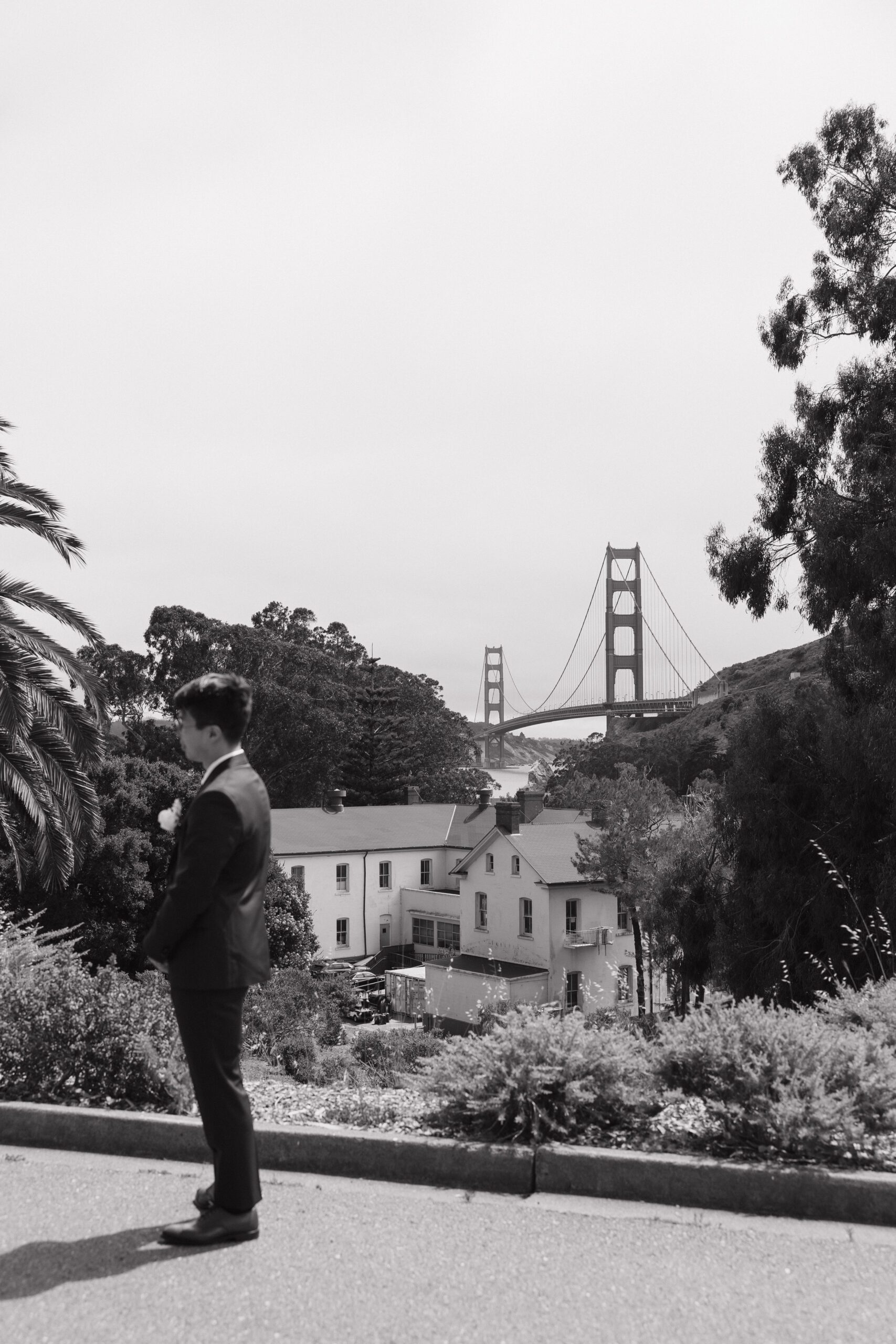 A groom waiting on his bride for a first look with the Golden Gate Bridge behind him