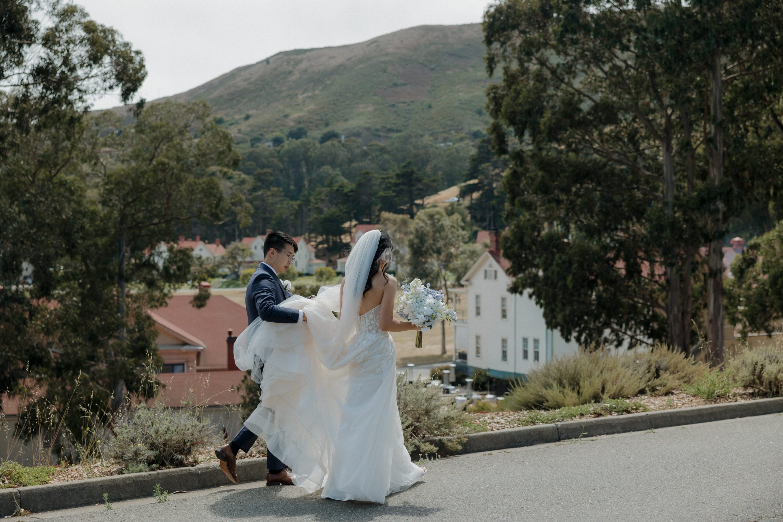 A bride and groom walking together in a candid wedding photo