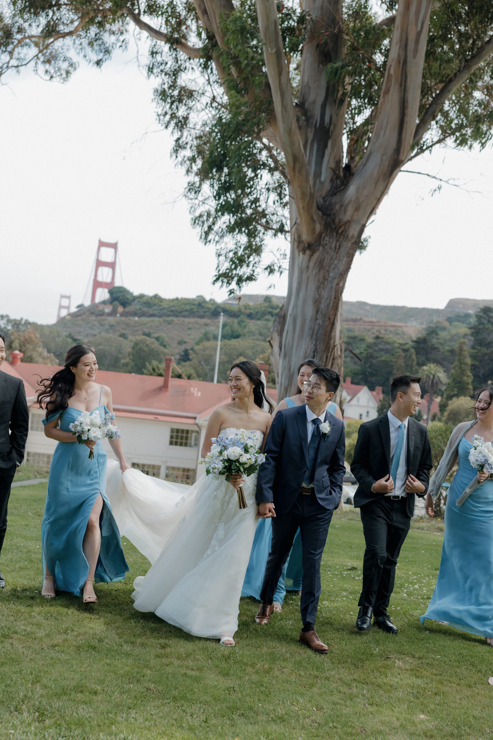 A wedding party walking across a lawn at a San Francisco wedding venue