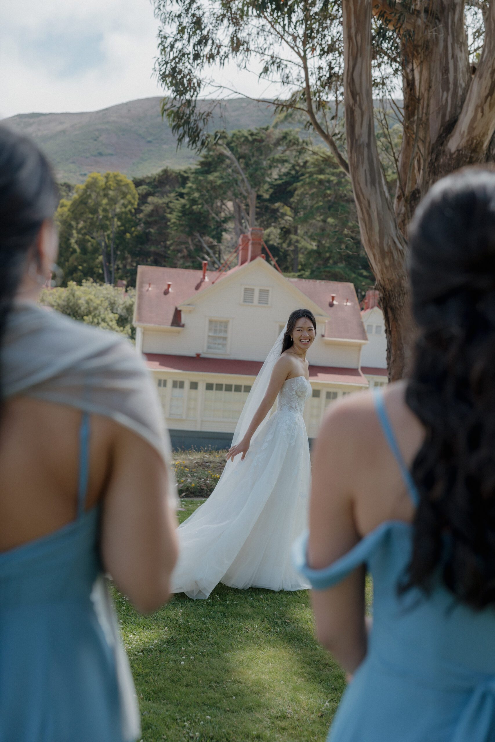Bridesmaids watching a bride spin in her dress