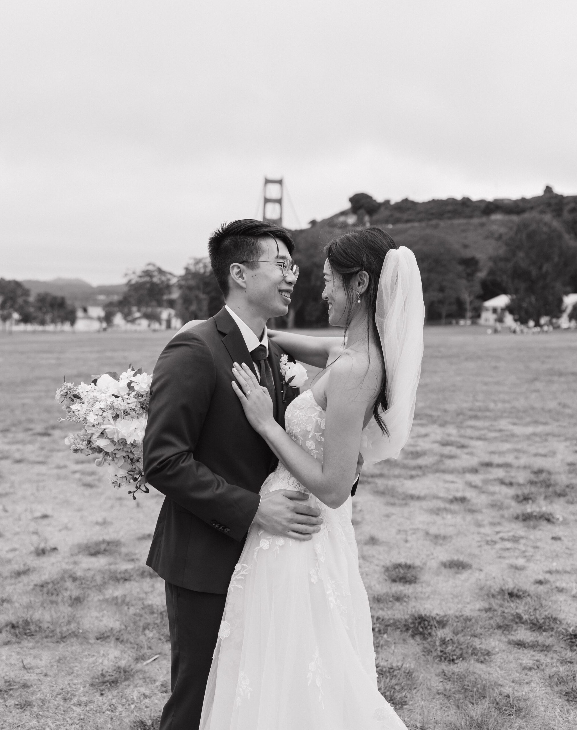 A bride and groom laughing during wedding photos