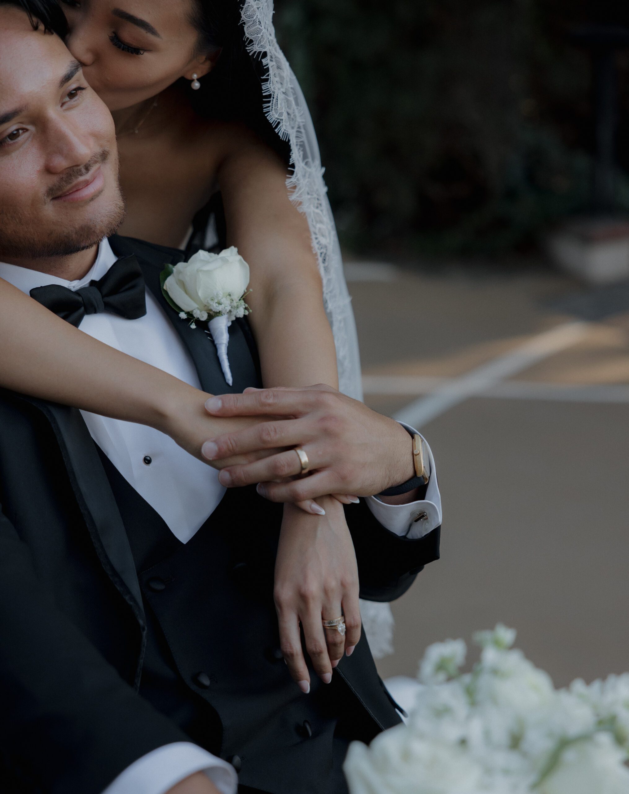 A bride and groom posing for wedding portraits