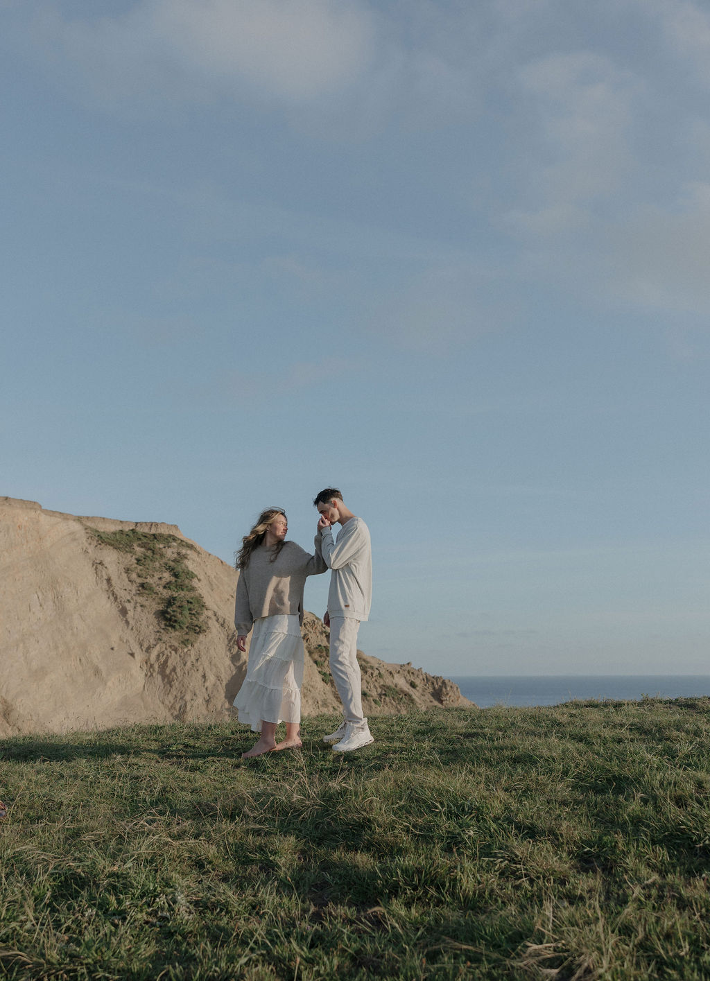 A couple walking hand-in-hand in Point Reyes National Park