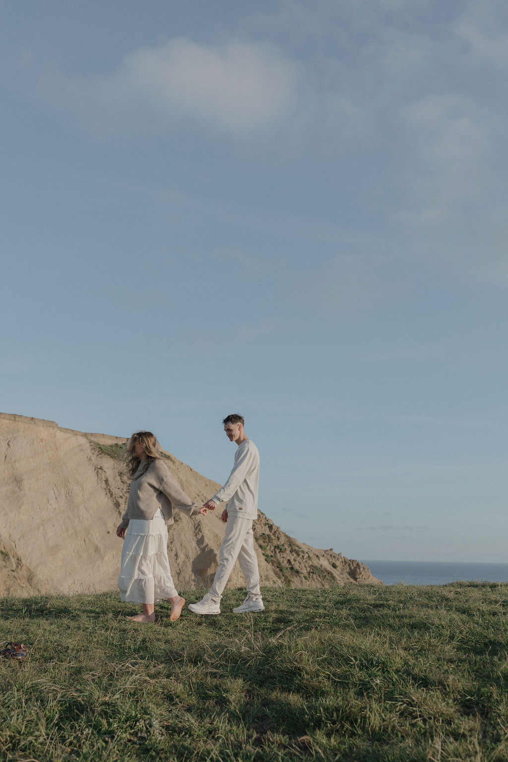 A couple walking hand-in-hand in Point Reyes National Park
