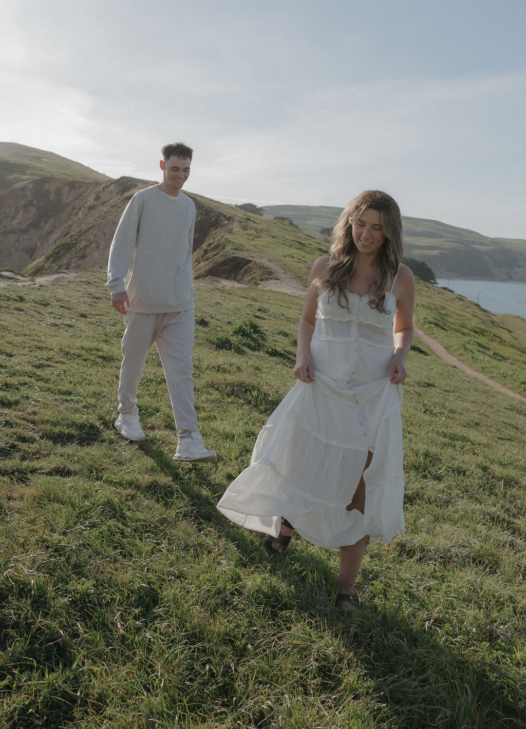 A couple walking through Point Reyes National Park for engagement photos