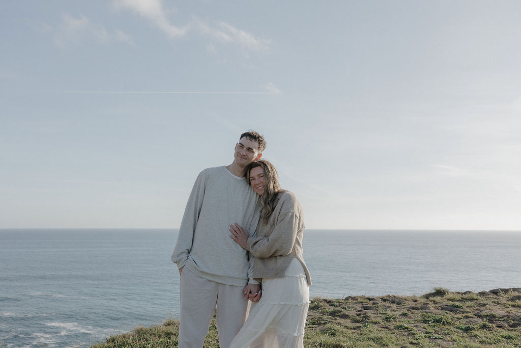 A couple taking engagement photos on a mountain in Point Reyes national park