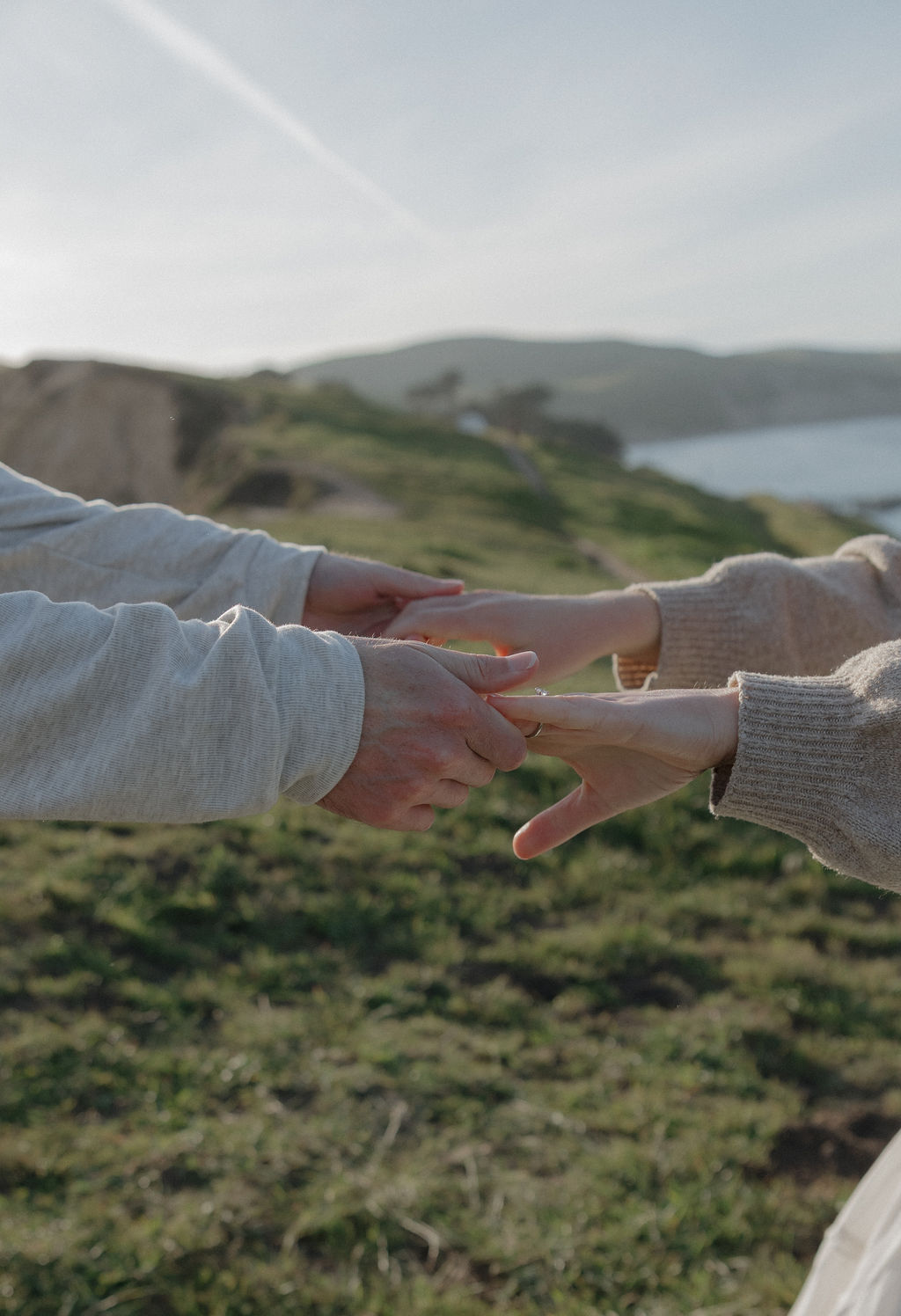A couple holding hands while dancing during their engagement photoshoot