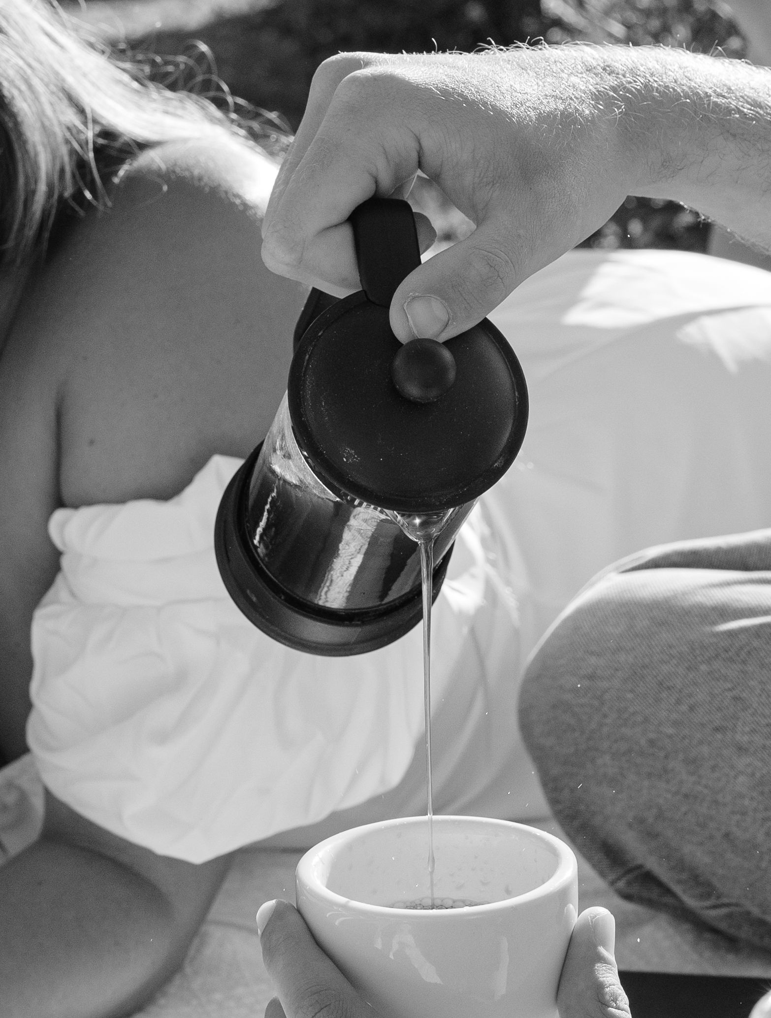 A man pouring coffee for his fiancee