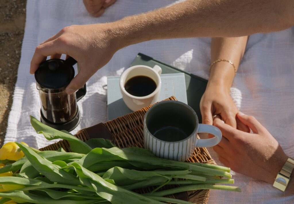 A cuple making coffee together during their Malibu Beach engagement photos